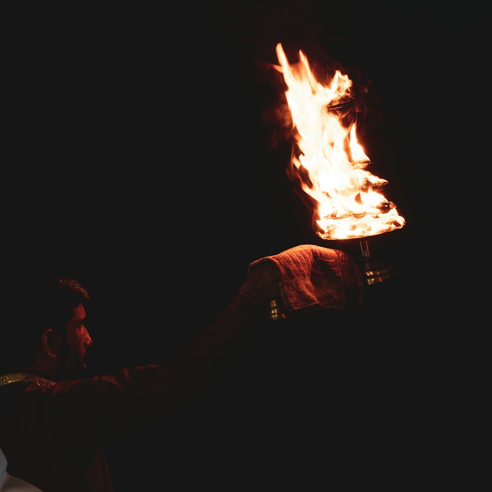 a man holding a fire pit in his hand