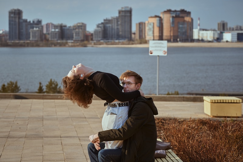 Couple sitting by scenic water