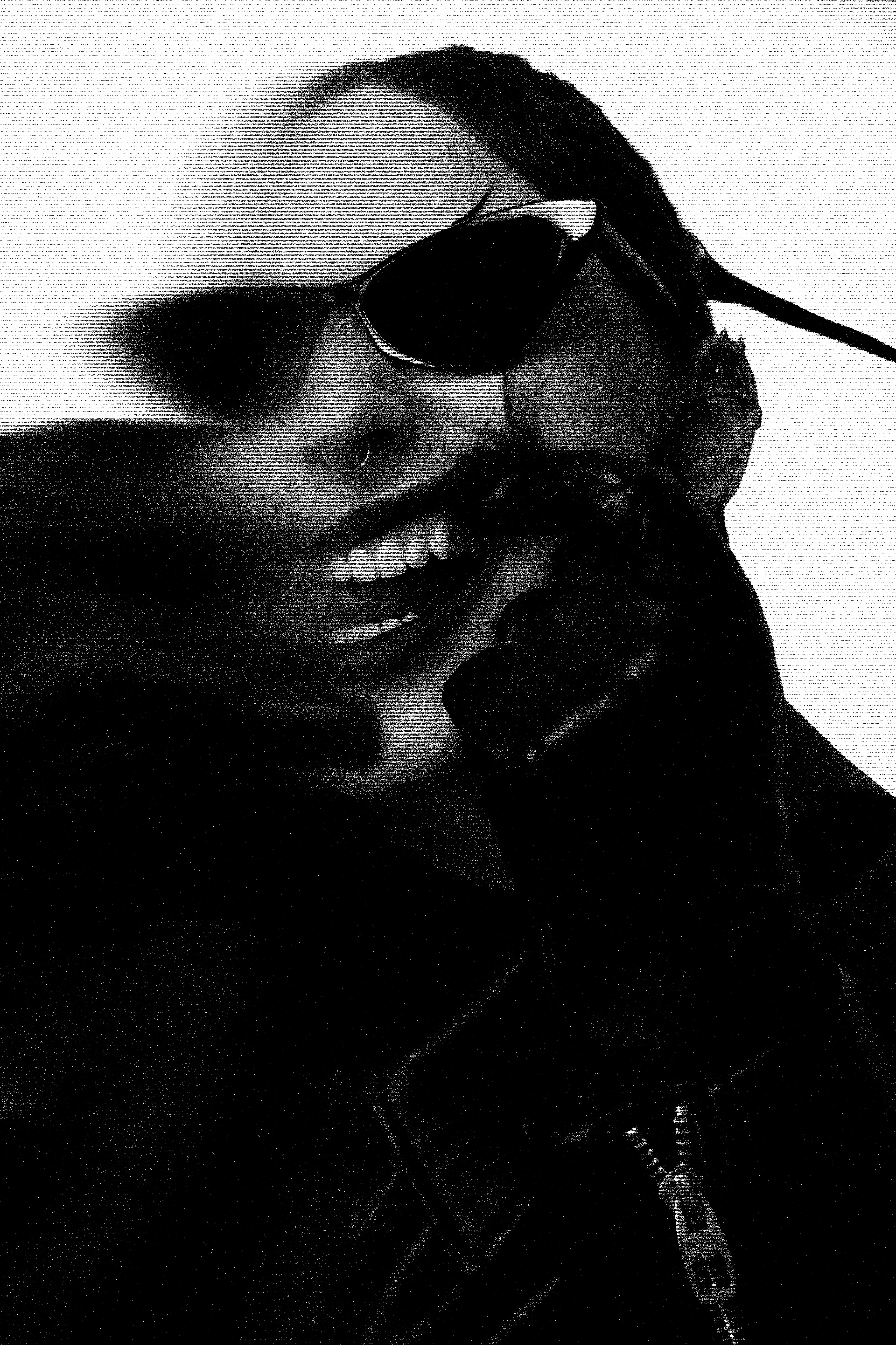 a woman talking on a cell phone while wearing sunglasses