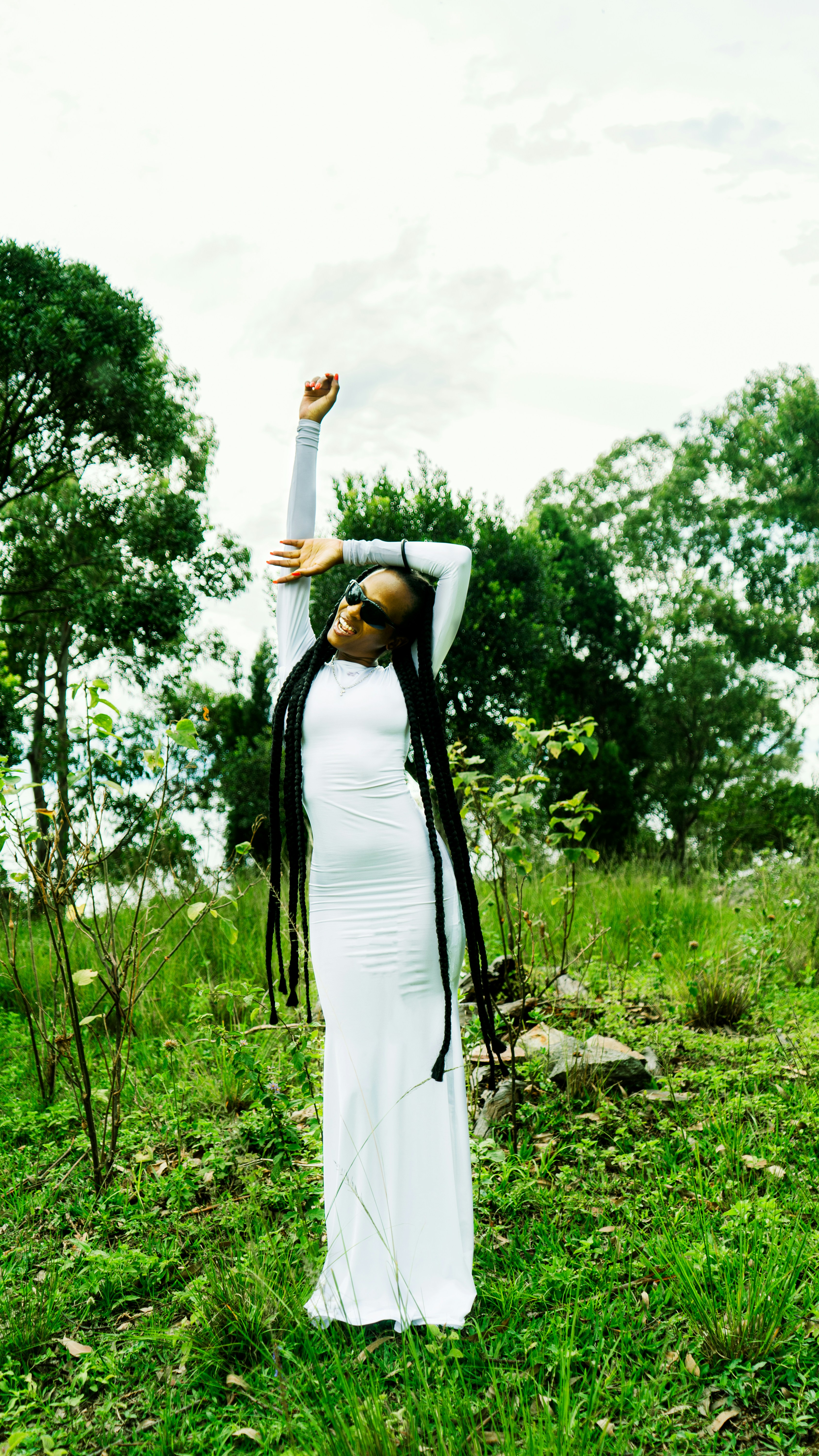 a woman in a white dress standing in a field