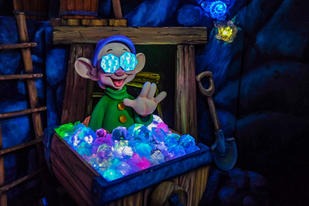 a cartoon character with glowing eyes in front of a display