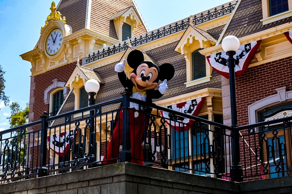 a mickey mouse statue on top of a building