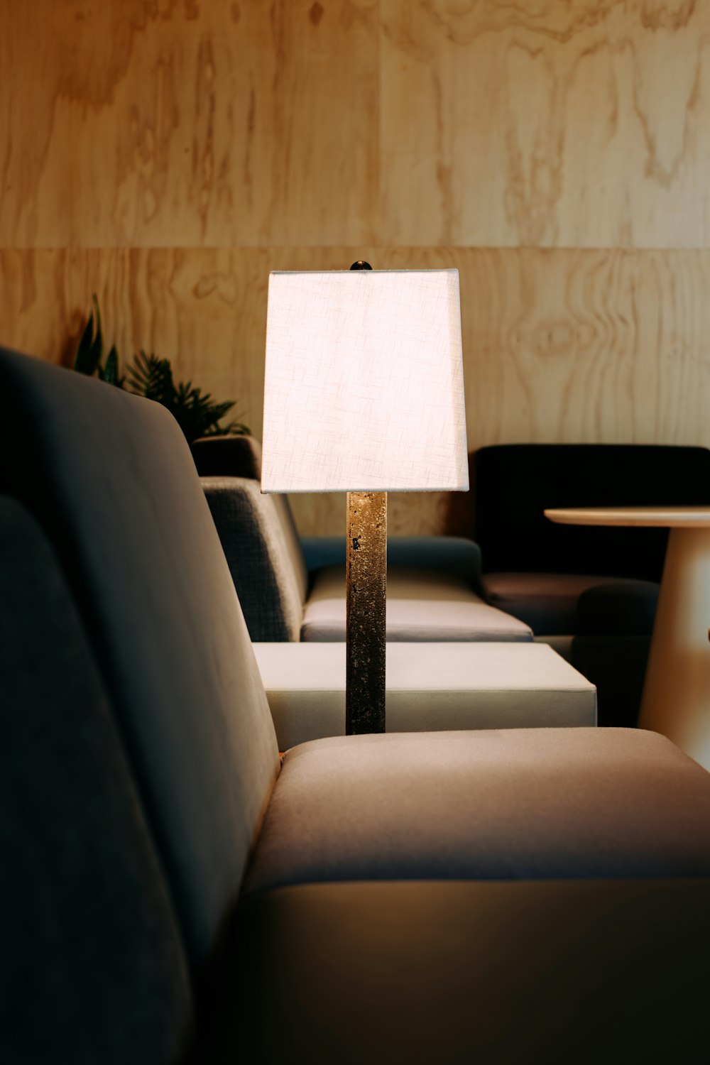 a lamp sitting on top of a table next to a couch