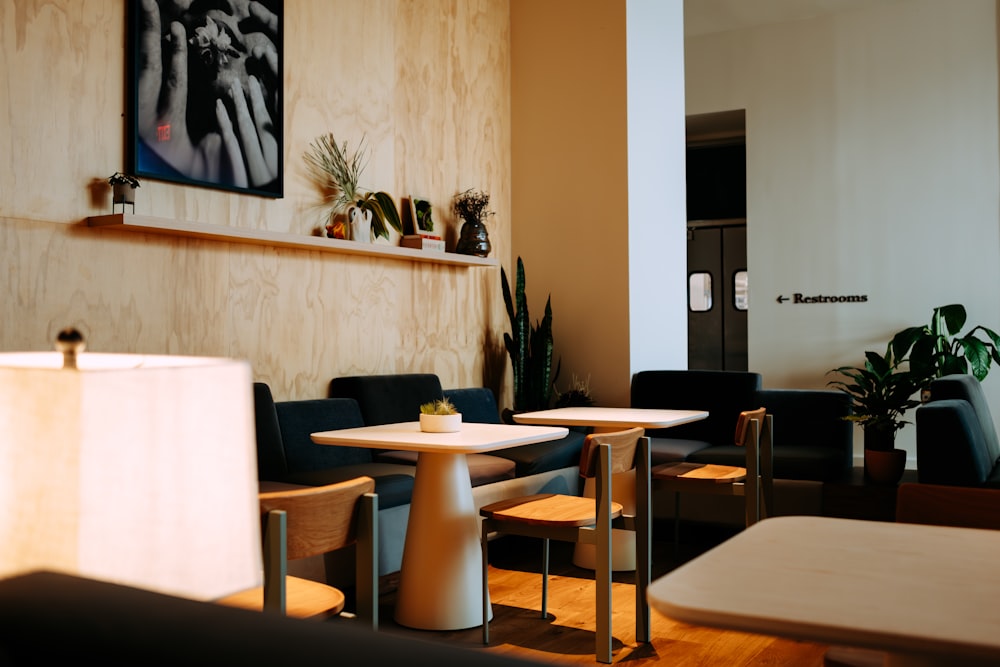 a restaurant with tables and chairs and a painting on the wall