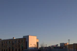 Finished commercial complex with clean lines and landscaped surroundings at sunset.
