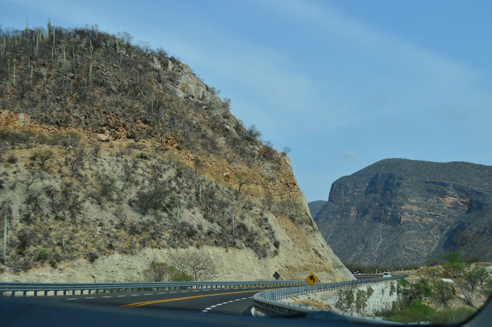 a view of a mountain from inside a car