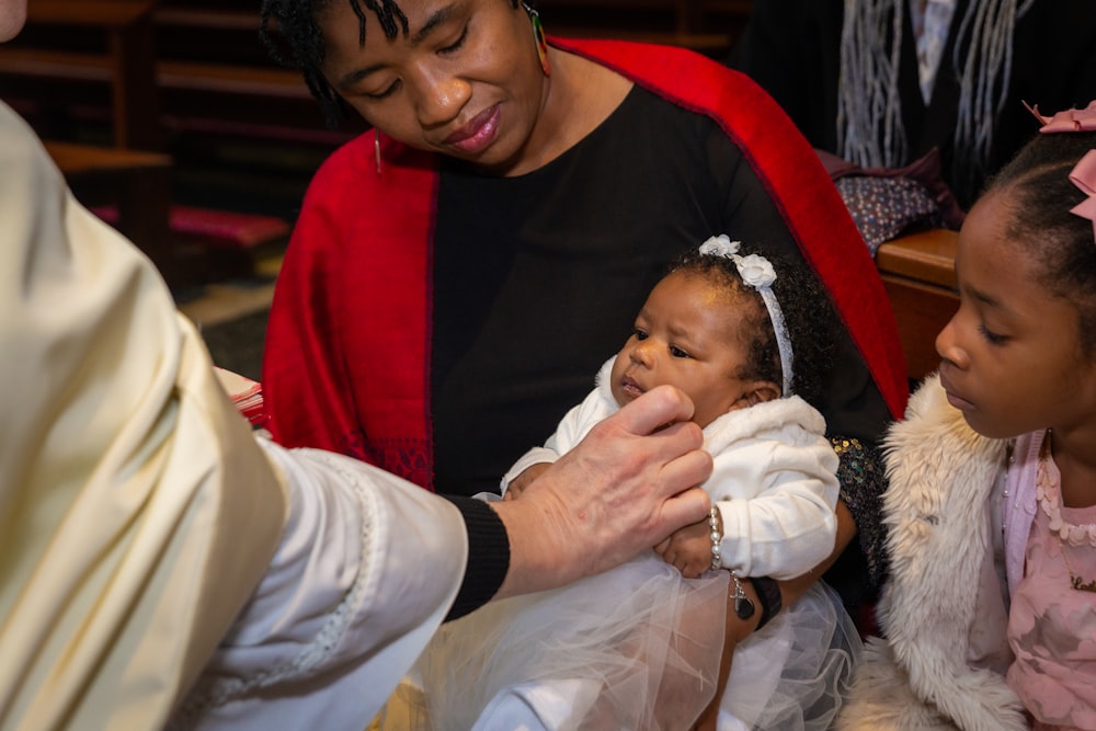 a woman holding a baby in a church