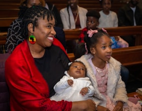 a woman holding a baby in a church