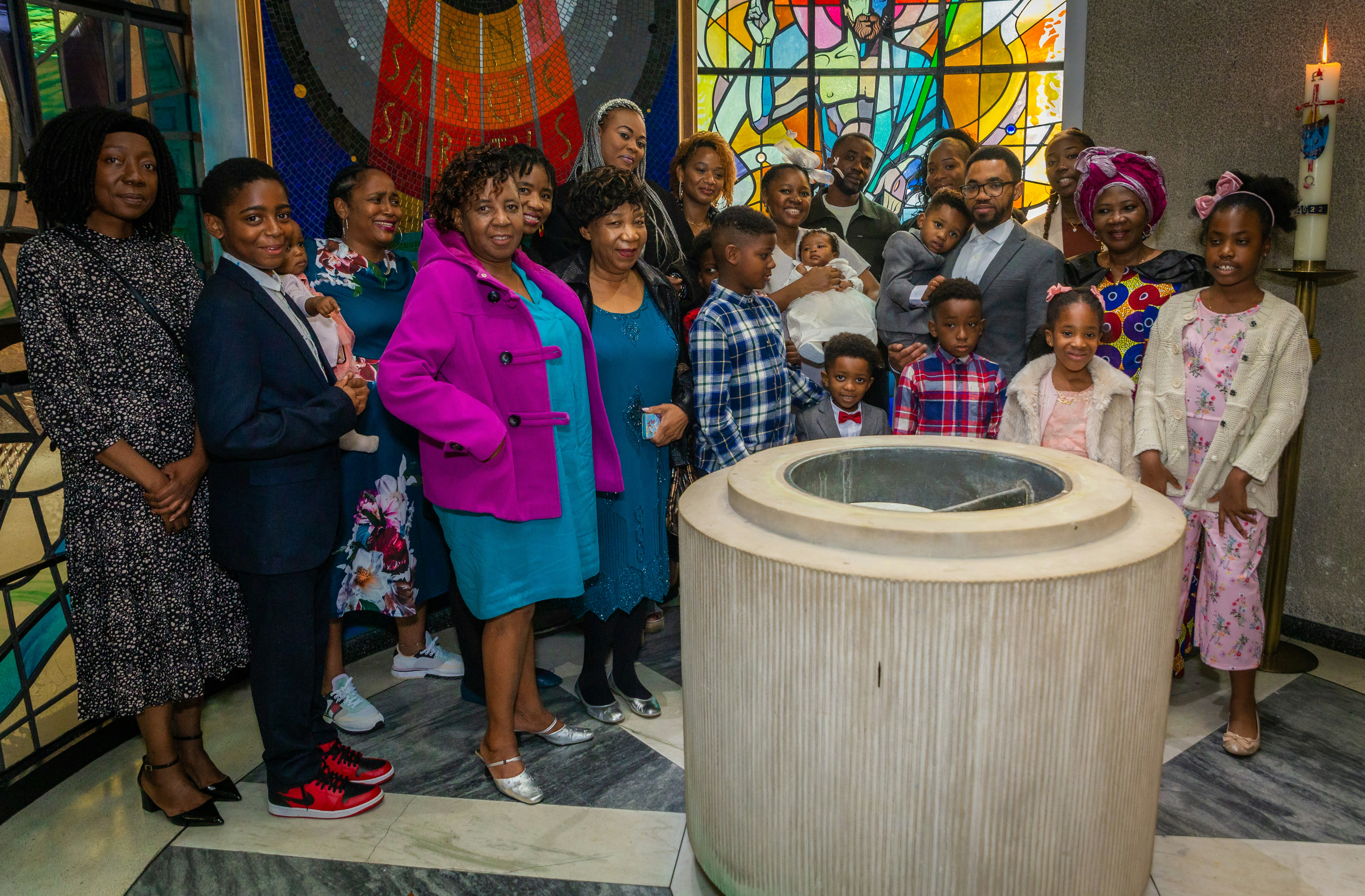 a group of people standing in front of a stained glass window