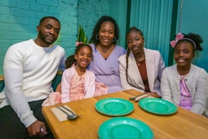 a group of people sitting around a wooden table