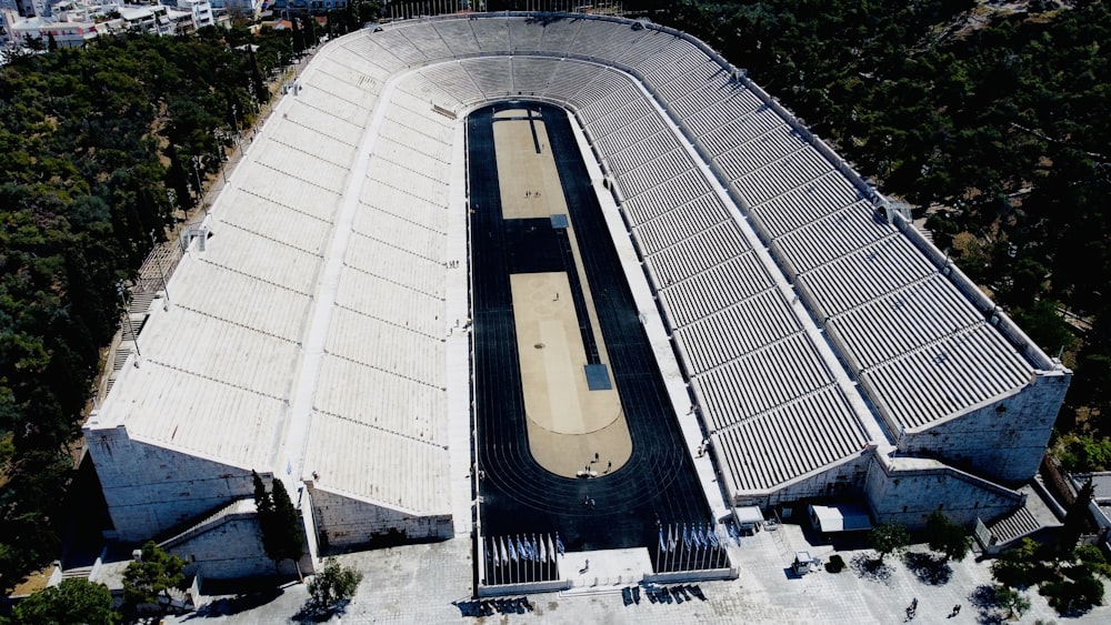 an aerial view of a building with a train on the track