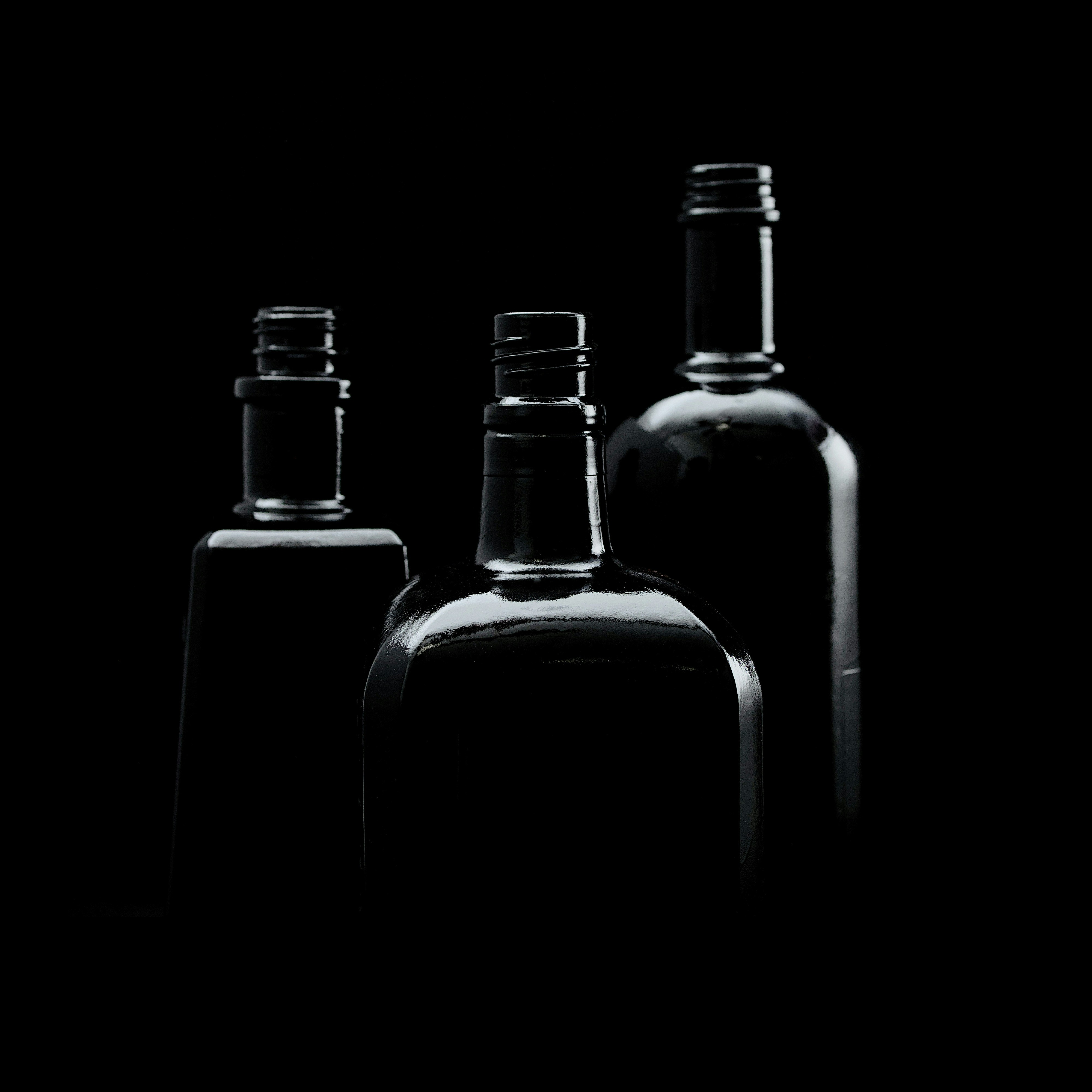 three empty bottles are shown in black and white