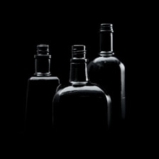 three empty bottles are shown in black and white
