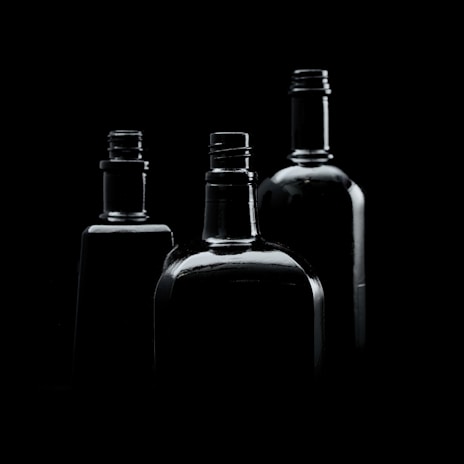 Elegant arrangement of nctr bottles on a black surface with soft lighting highlighting the label.