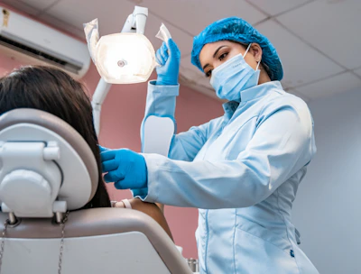 A patient receiving a comfortable dental filling in a calm, mint-themed room.