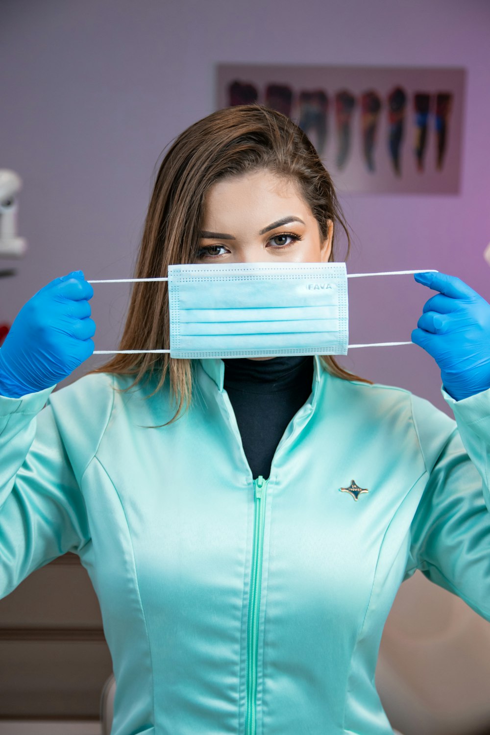 a woman wearing a face mask and blue gloves