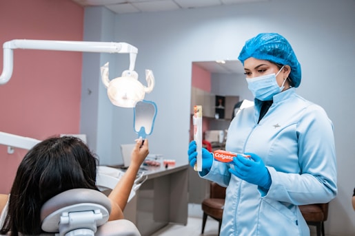 a woman in a dentist's office holding a toothbrush