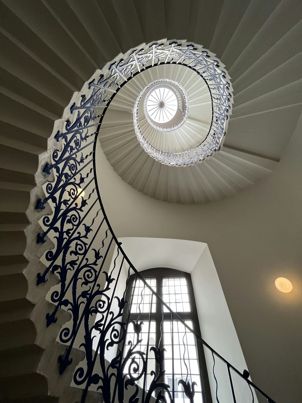 a spiral staircase in a building with a window