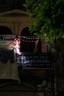 String lights draped across a balcony railing, casting a gentle, inviting glow.
