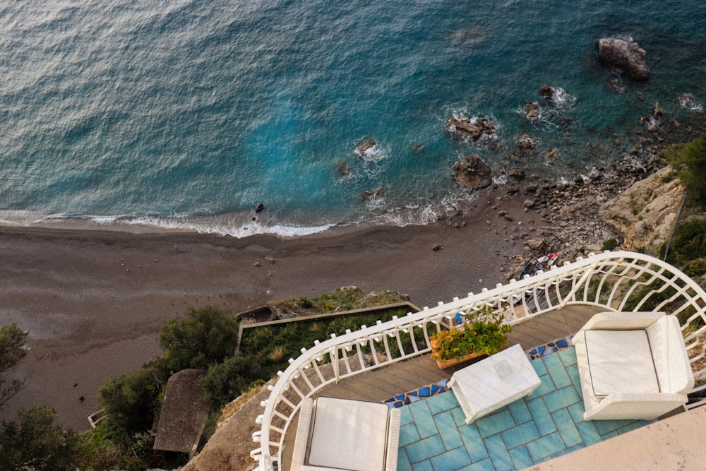 an aerial view of a pool and a beach