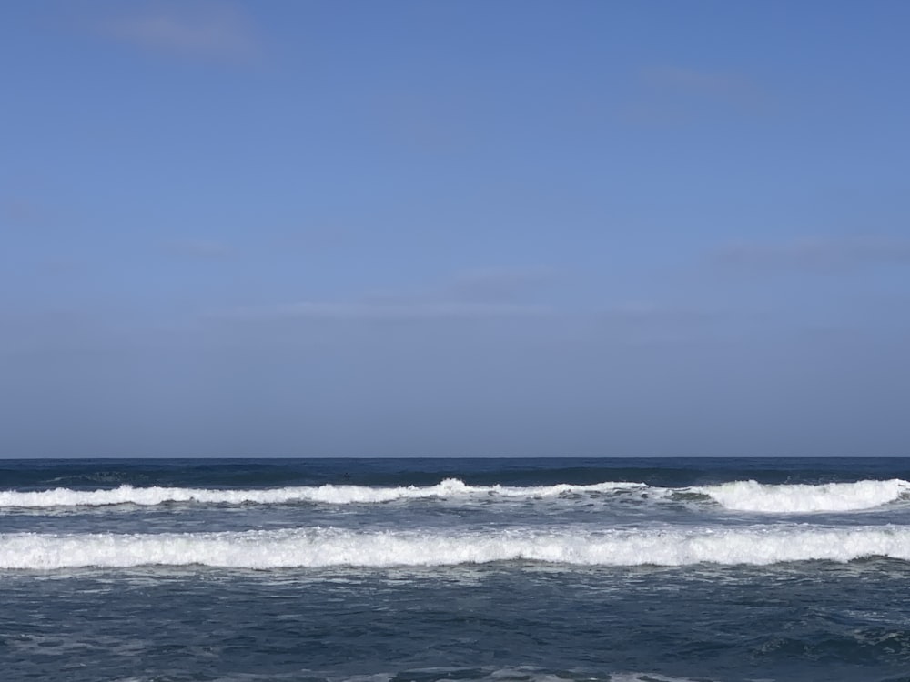 a man riding a surfboard on top of a wave in the ocean