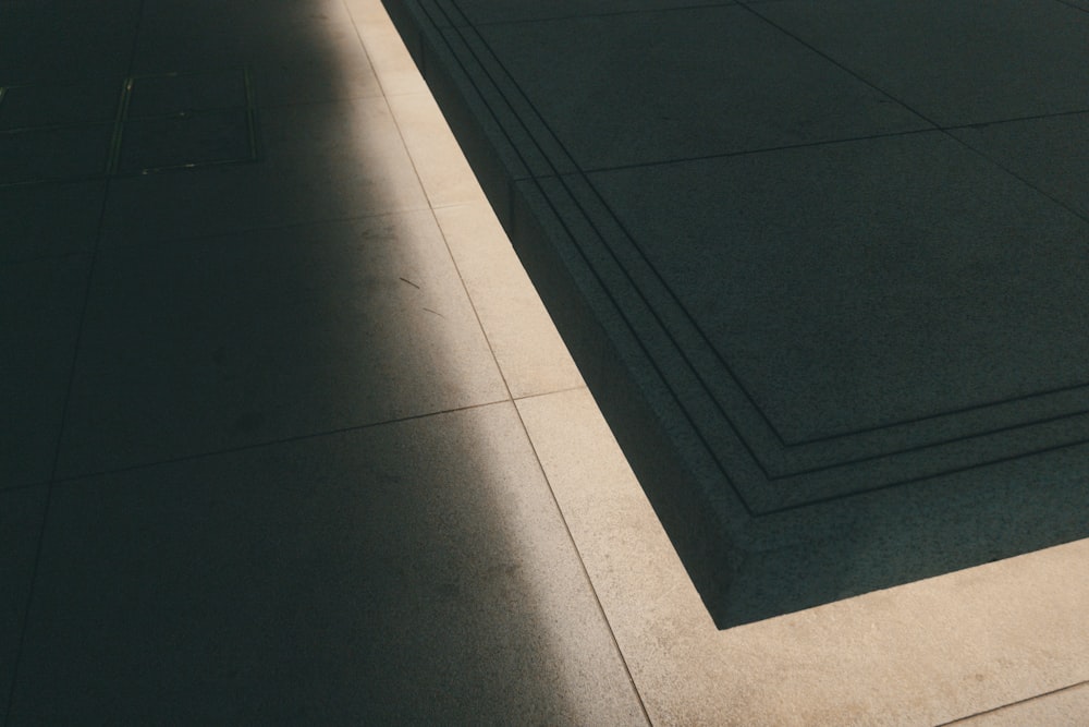 a skateboard is laying on the ground in the sun