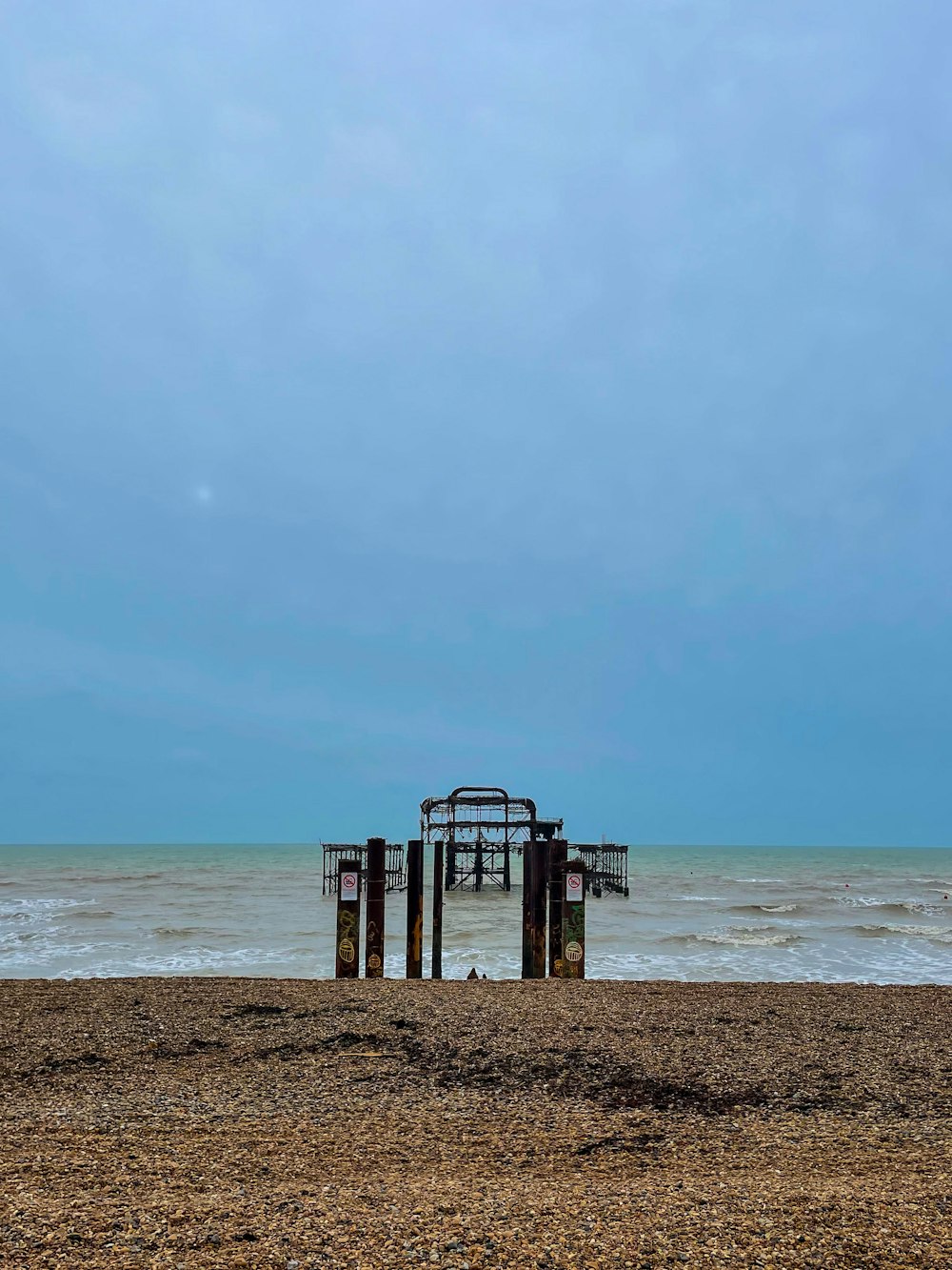 a couple of gates sitting on top of a sandy beach