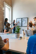 Team of creative marketers brainstorming strategies in a bright, modern office space.