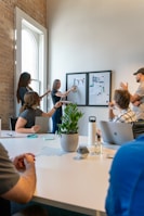 A team brainstorming session with charts and awards in view.
