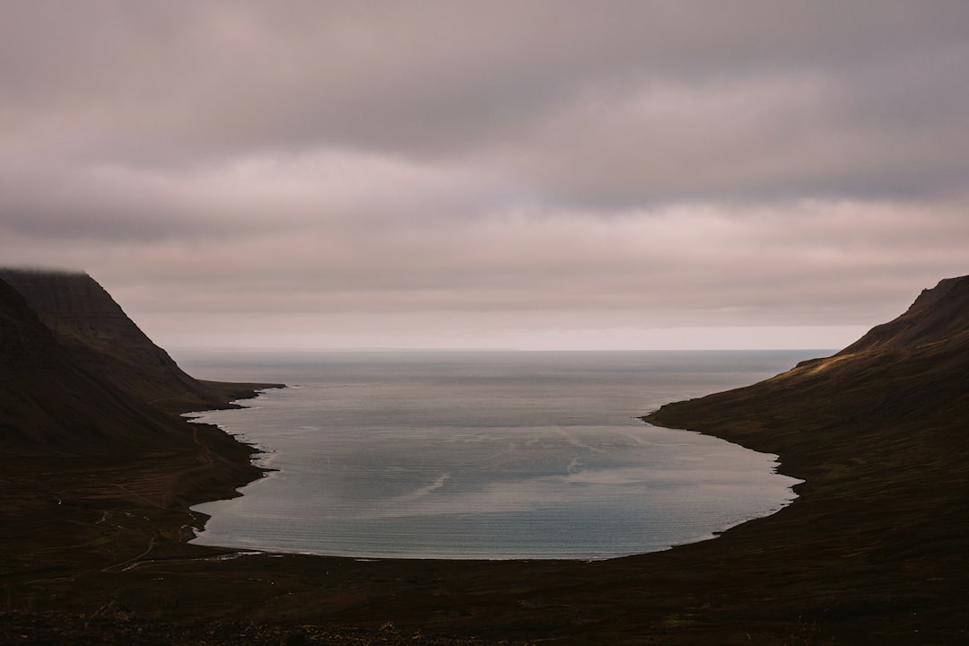 a large body of water surrounded by mountains, Sunset view looking west from the ring road.