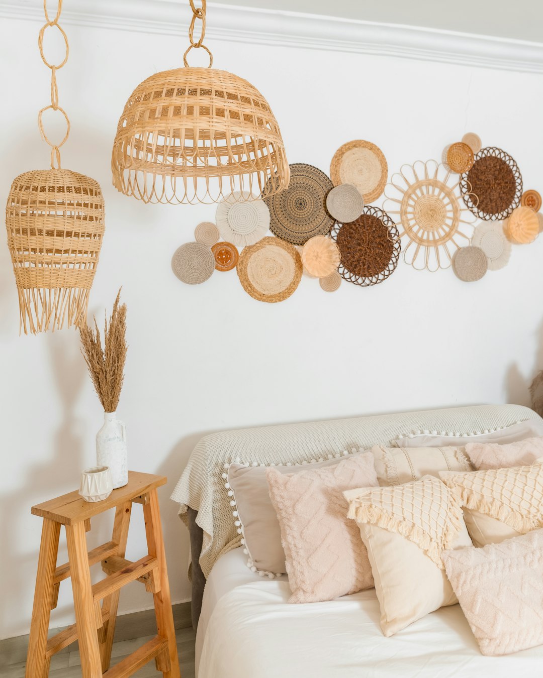 Woven wall baskets and rattan pendant lights above a cozy bed