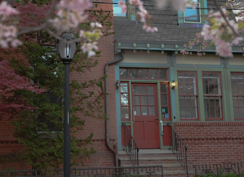 a red door is on the side of a brick building