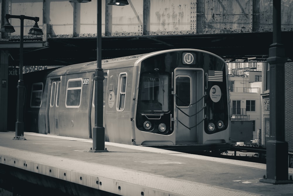 a black and white photo of a train at a train station