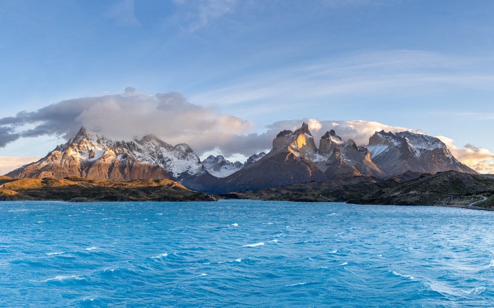 a large body of water with mountains in the background