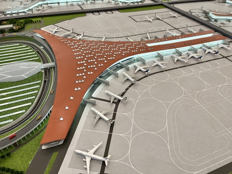 Students engaged in a classroom learning about aviation management with airport models.