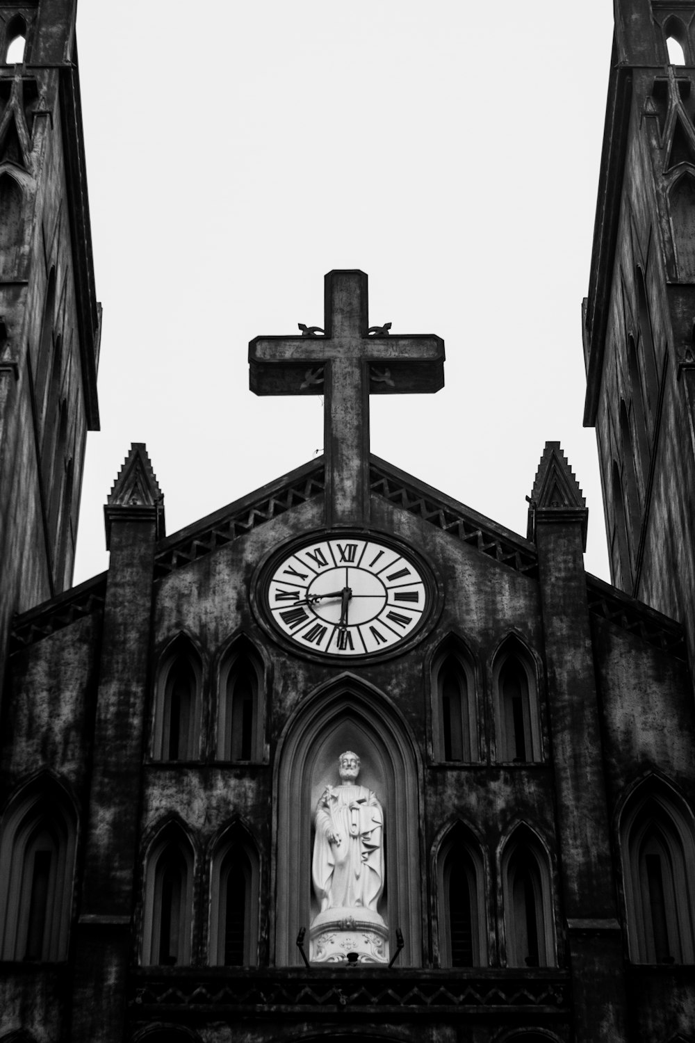 a black and white photo of a church with a clock