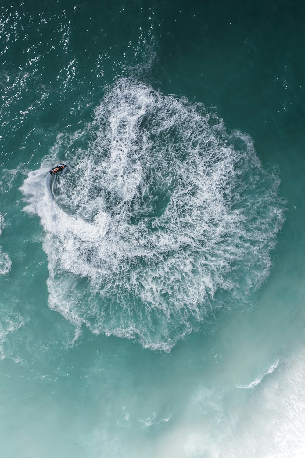 a person riding a surfboard on a wave in the ocean