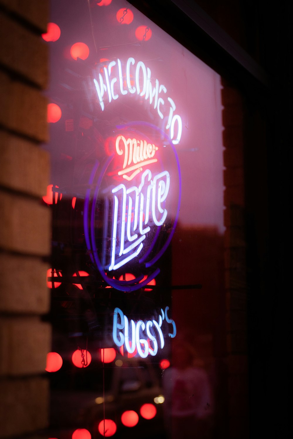 a neon sign that says welcome to the diner