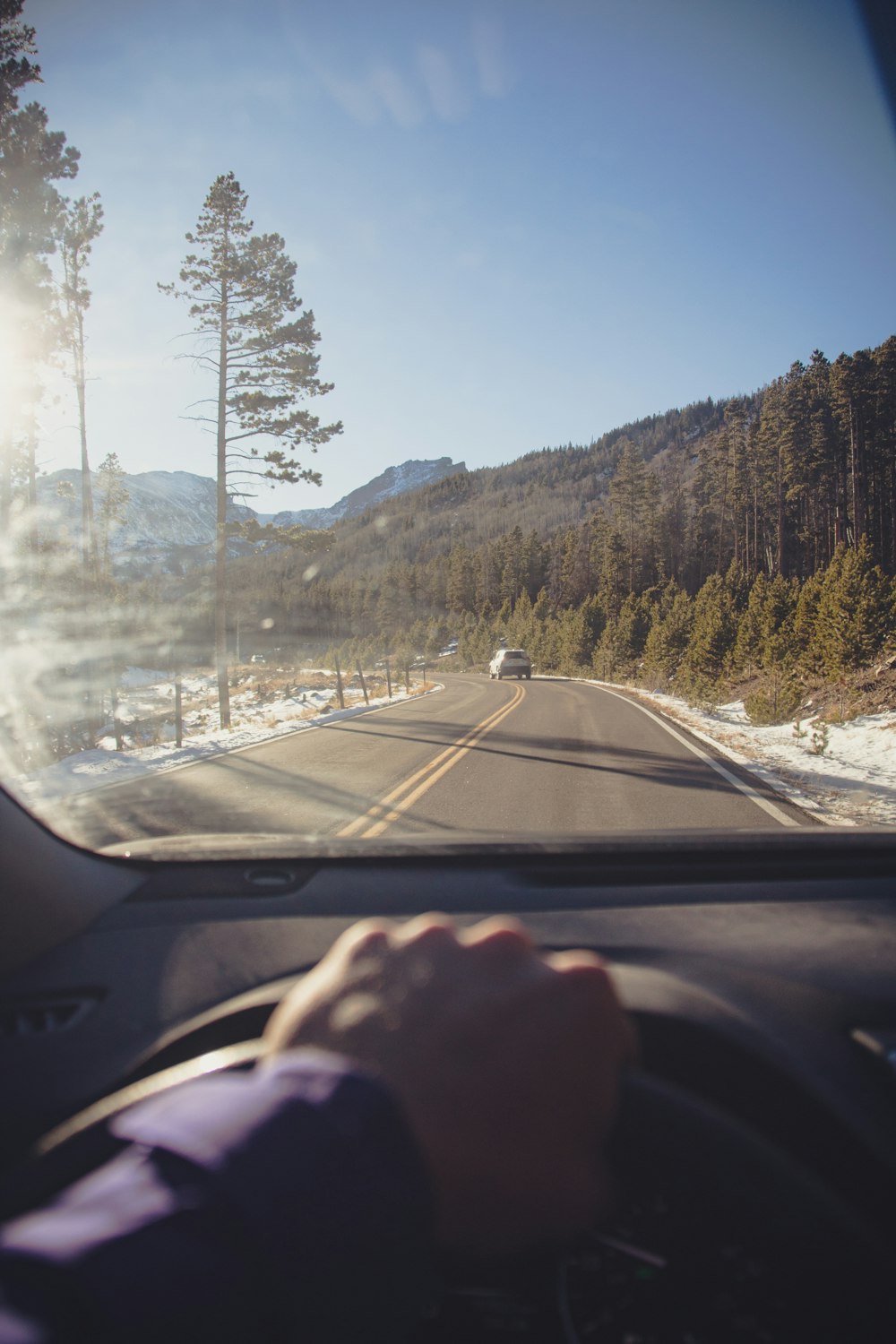 a person driving a car on a snowy road