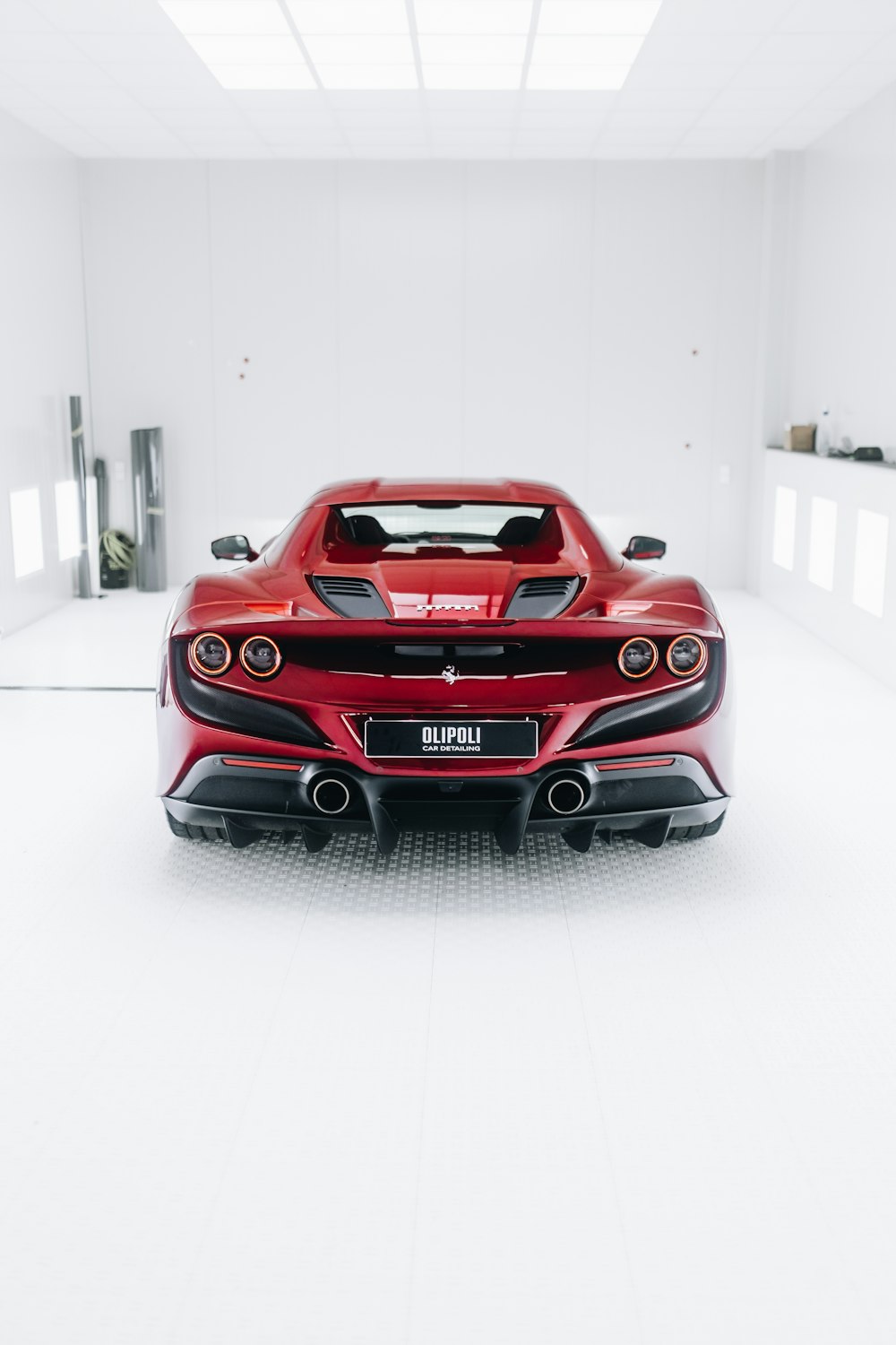 a red sports car parked in a white room