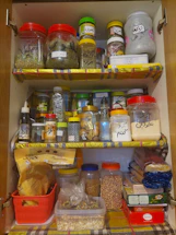 A neatly arranged pantry with labeled jars and baskets, inviting and organized.