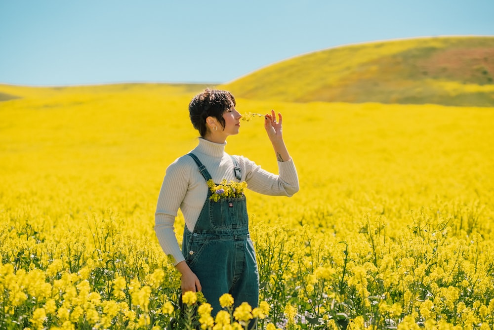 a woman standing in a field of yellow flowers