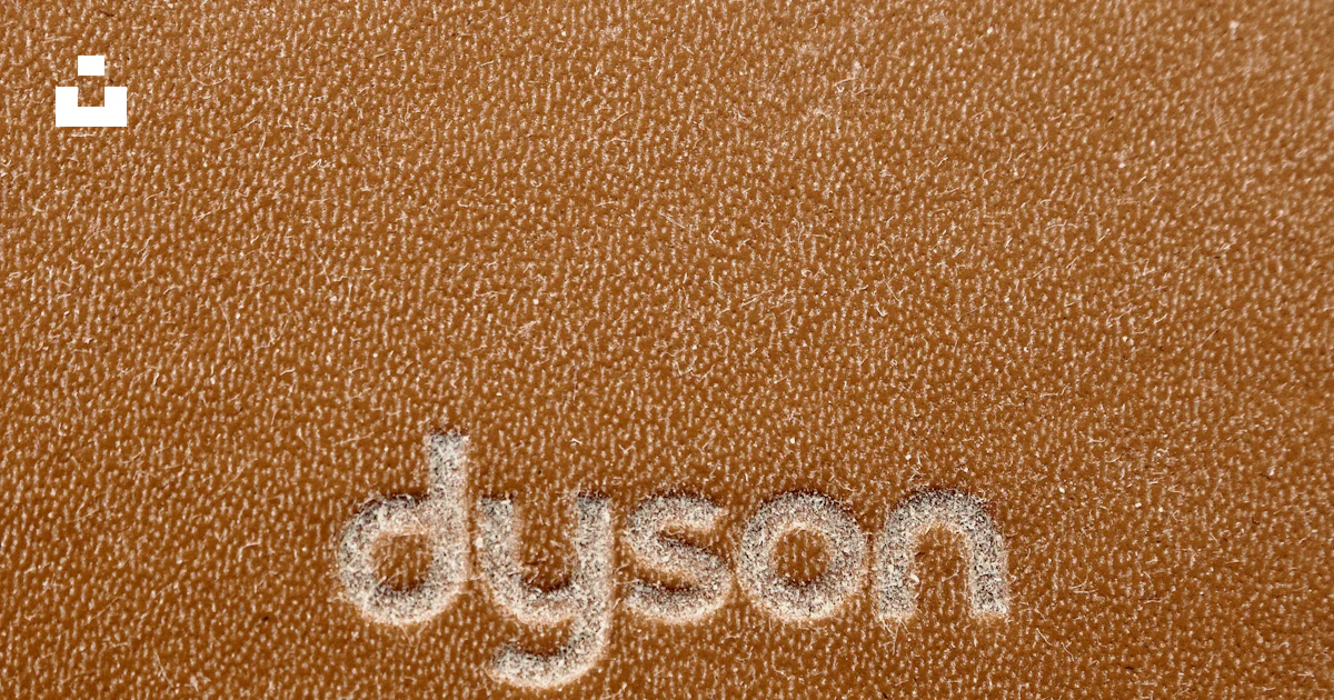A close up of the word dyson written on a leather surface photo – Free ...