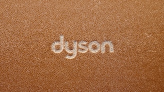 the word dyson written on a brown leather surface