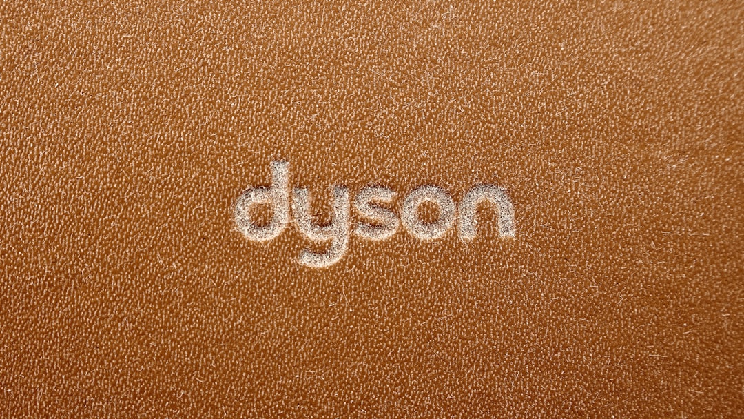 the word dyson written on a brown leather surface, Hair Dryer مجفف شعر