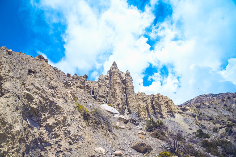 a rocky mountain with a sky background