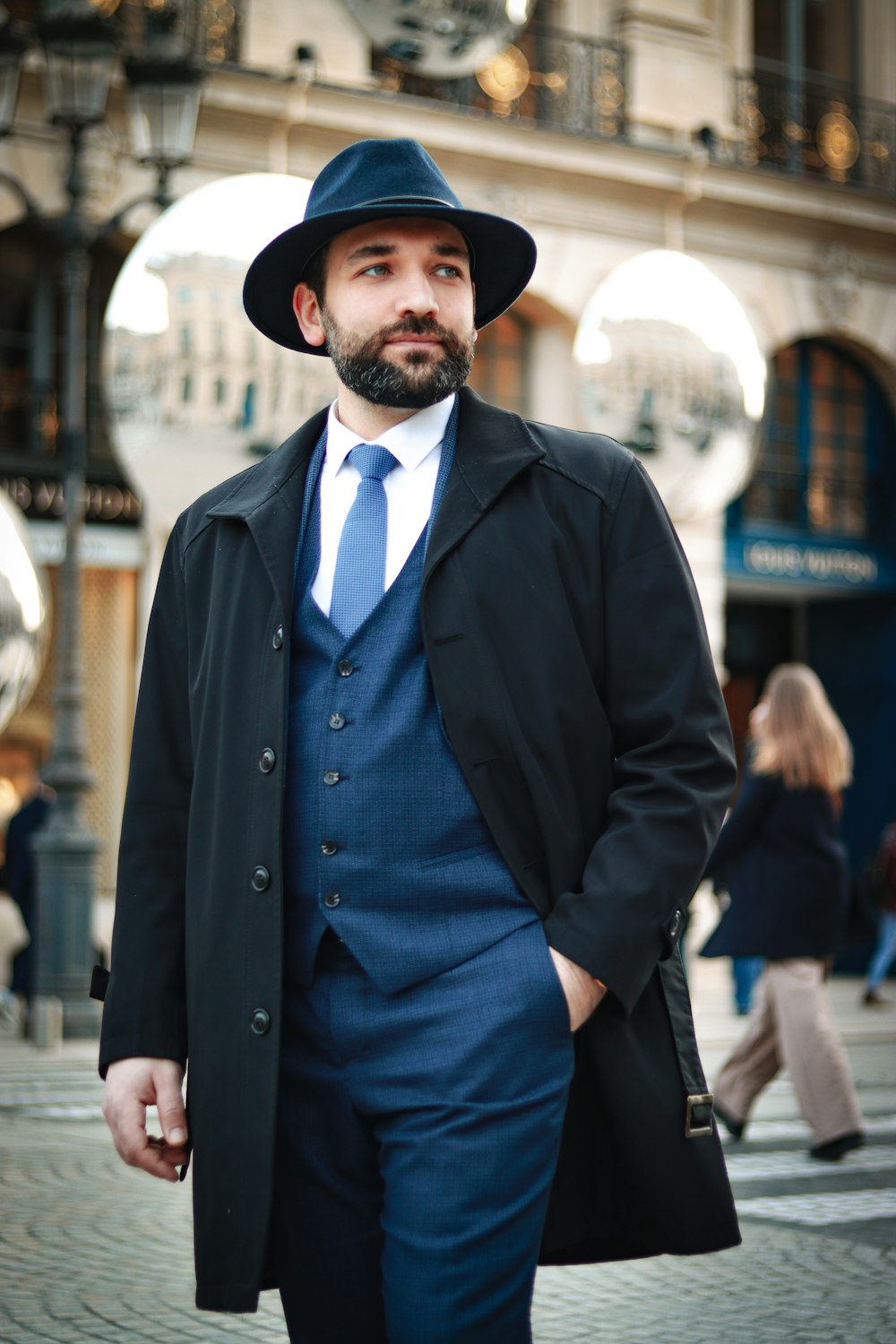 a man in a blue suit and hat