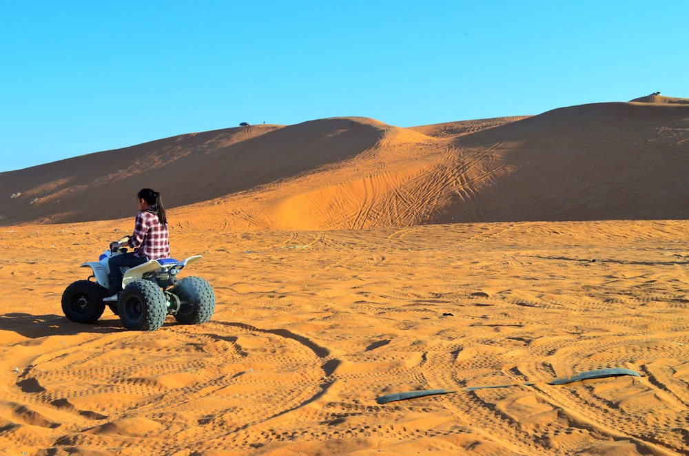 a person riding a four wheeler in the desert