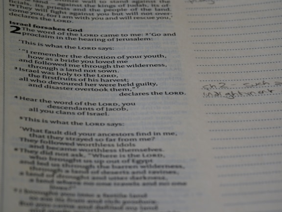 A close-up of an open Bible page with highlighted verses and handwritten notes.
