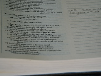 The image shows a page from a book with religious text, likely a Bible, featuring scriptural passages. The text includes questions posed as statements and mentions of the Lord and ancestors. On the right side, there's a lined margin with handwritten notes.